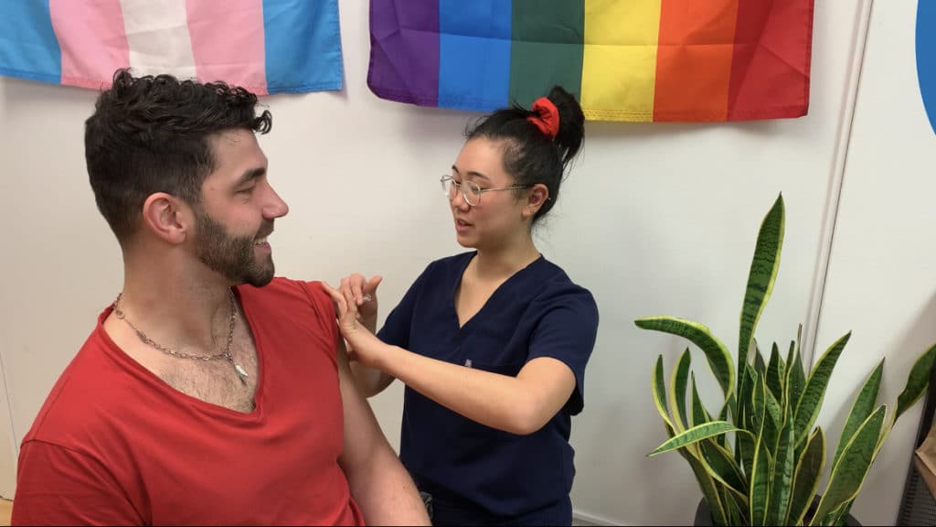 The PrEP Clinic Nurse Practitioner administering free sexual health vaccines to a PrEP patient.